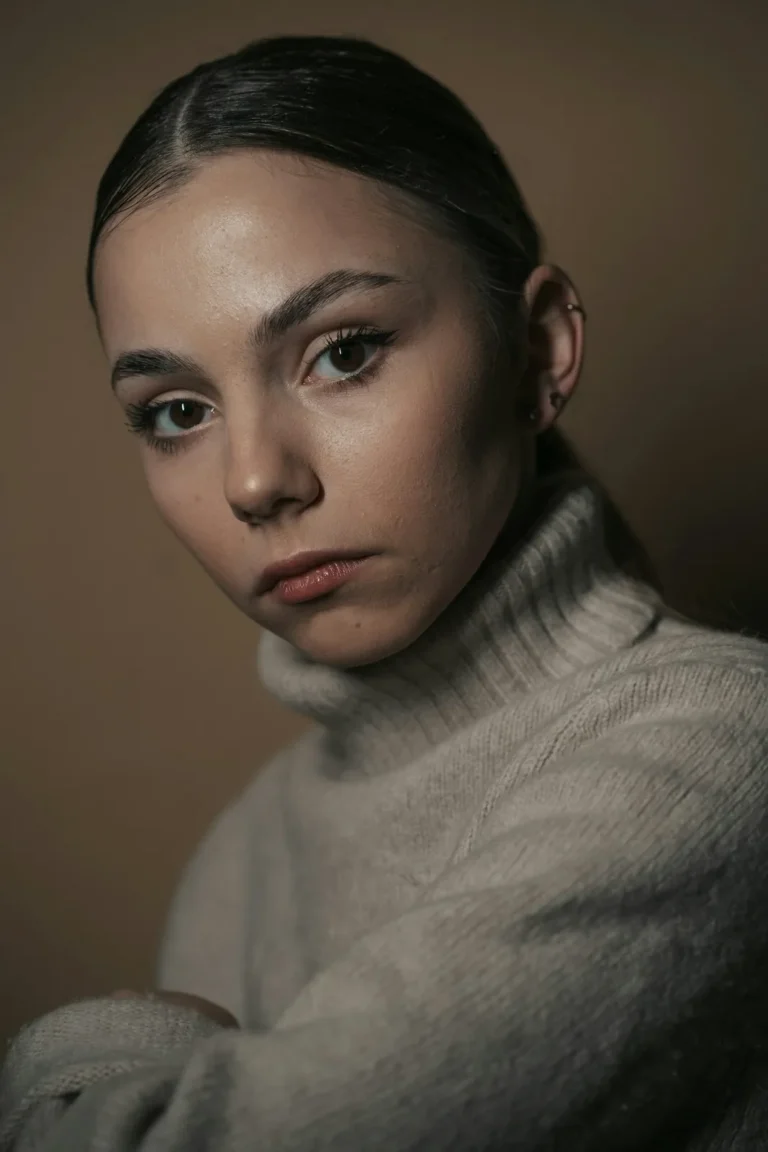 Lash artist in a cream sweater