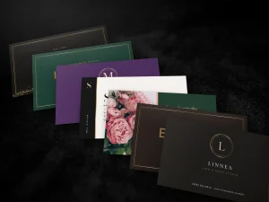 Foil triple-layer cards for nail salons, restaurants, bakeries and florists fanned on black velvet