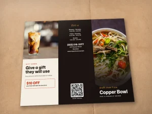 A restaurant brochure outside laid flat on a tablecloth