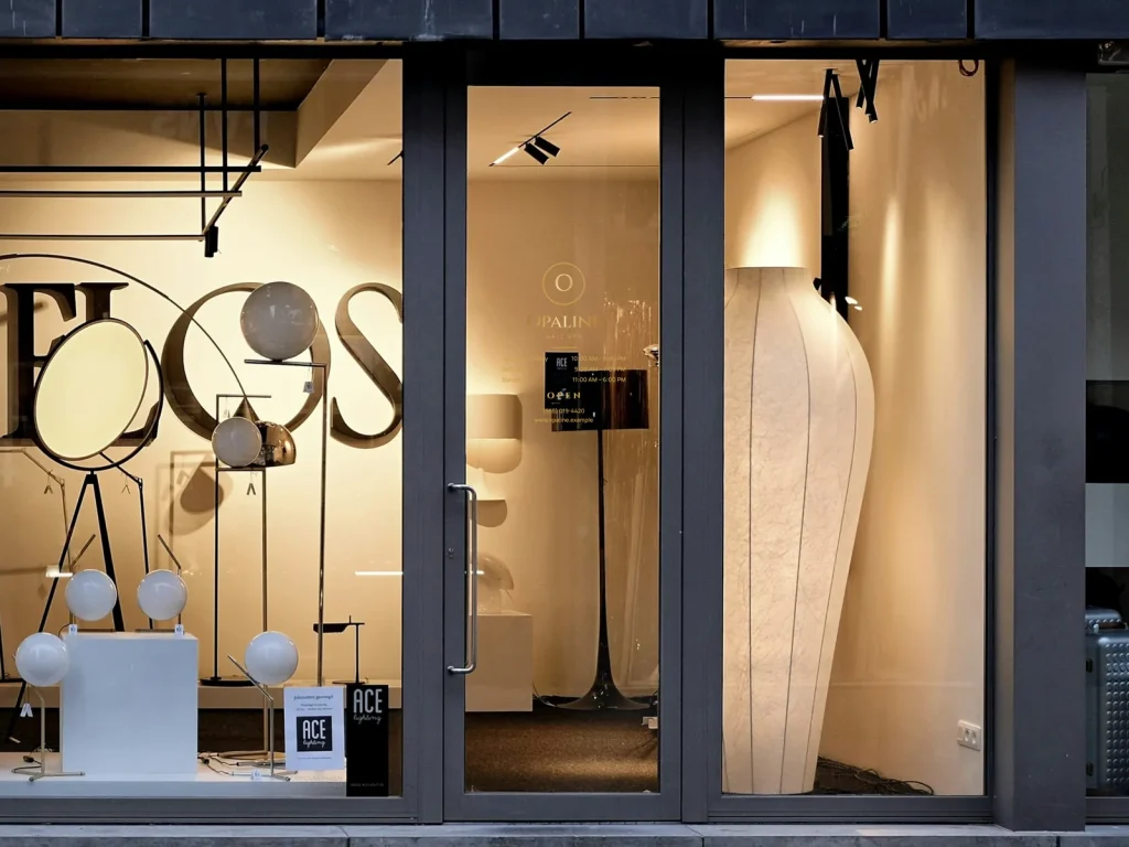 A gold door decal with logo, hours and phone on a nail salon’s glass door