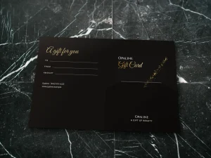 A black and gold glitter holder open with its gift card