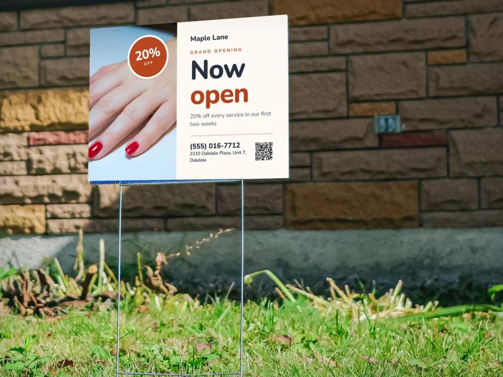 A nail salon grand opening yard sign on the lawn
