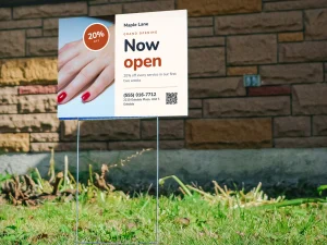 A nail salon grand opening yard sign on the lawn