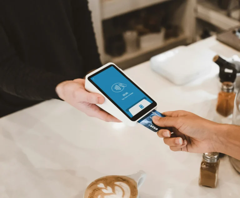 Customer paying by card on a handheld POS terminal