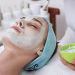 Client having a facial mask at a spa