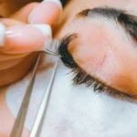 Lash artist applying eyelash extensions