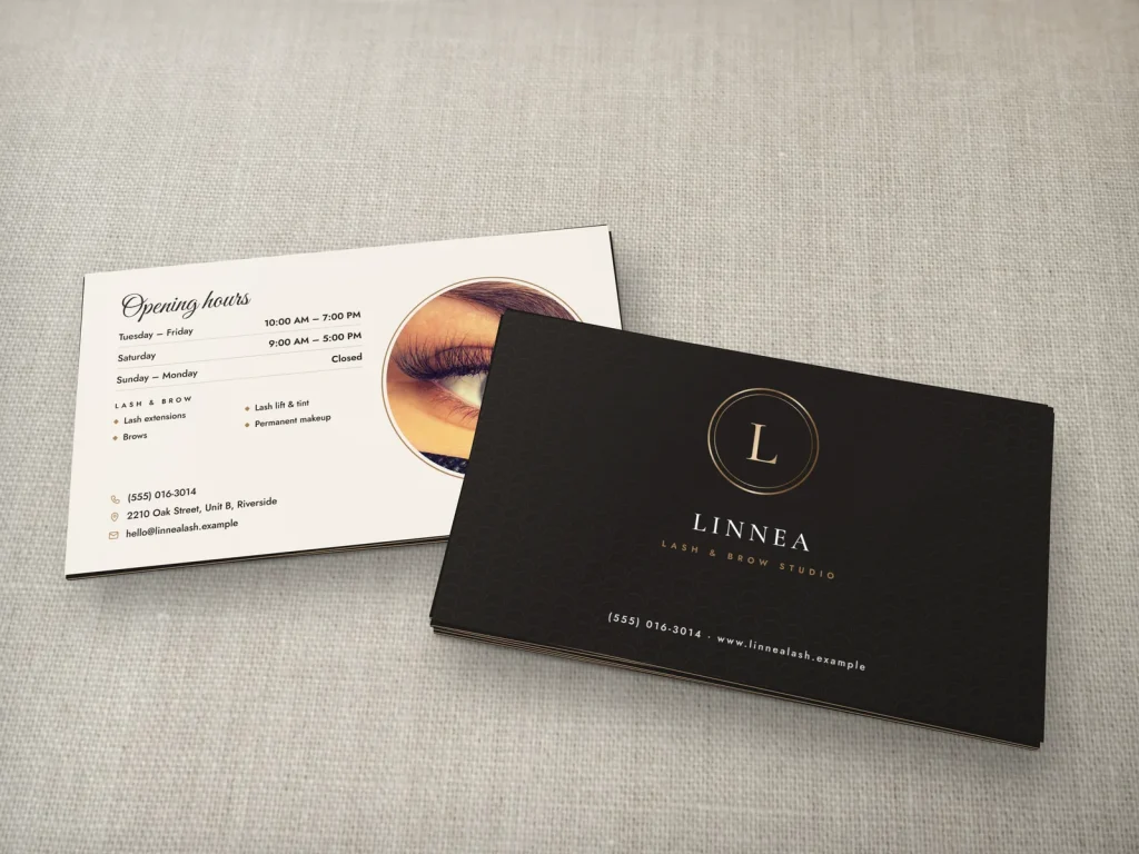 Triple-layer business card template BL-14 for a lash and brow studio: Linnea, black with a bronze foil L in a double ring