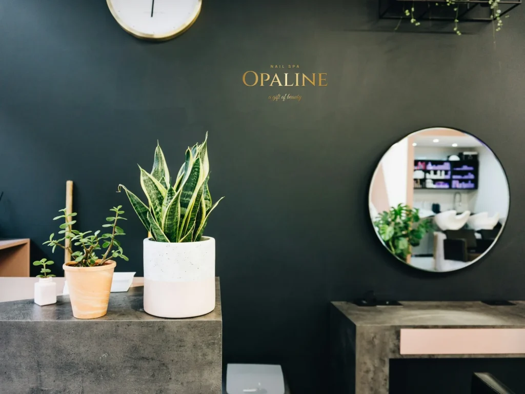 Cut vinyl lettering template CV-01 for a nail salon: Opaline, gold shop name on a dark green wall