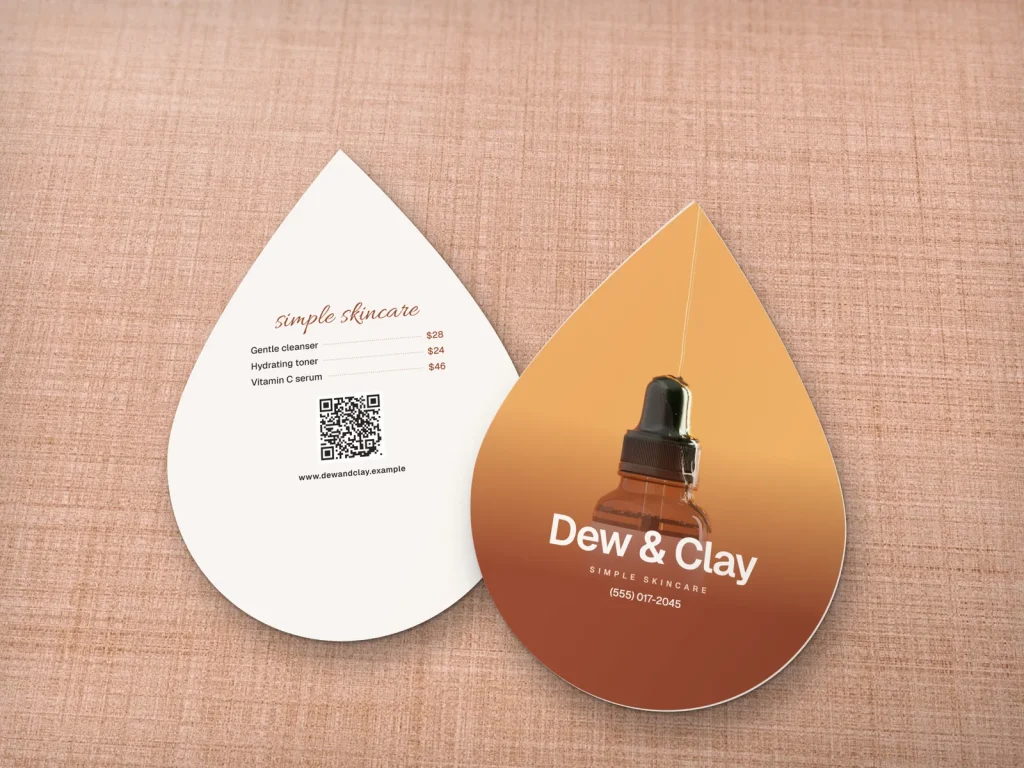 Die-cut business card template DC-16 for a shop: Dew & Clay, droplet shape with a golden serum dropper photo