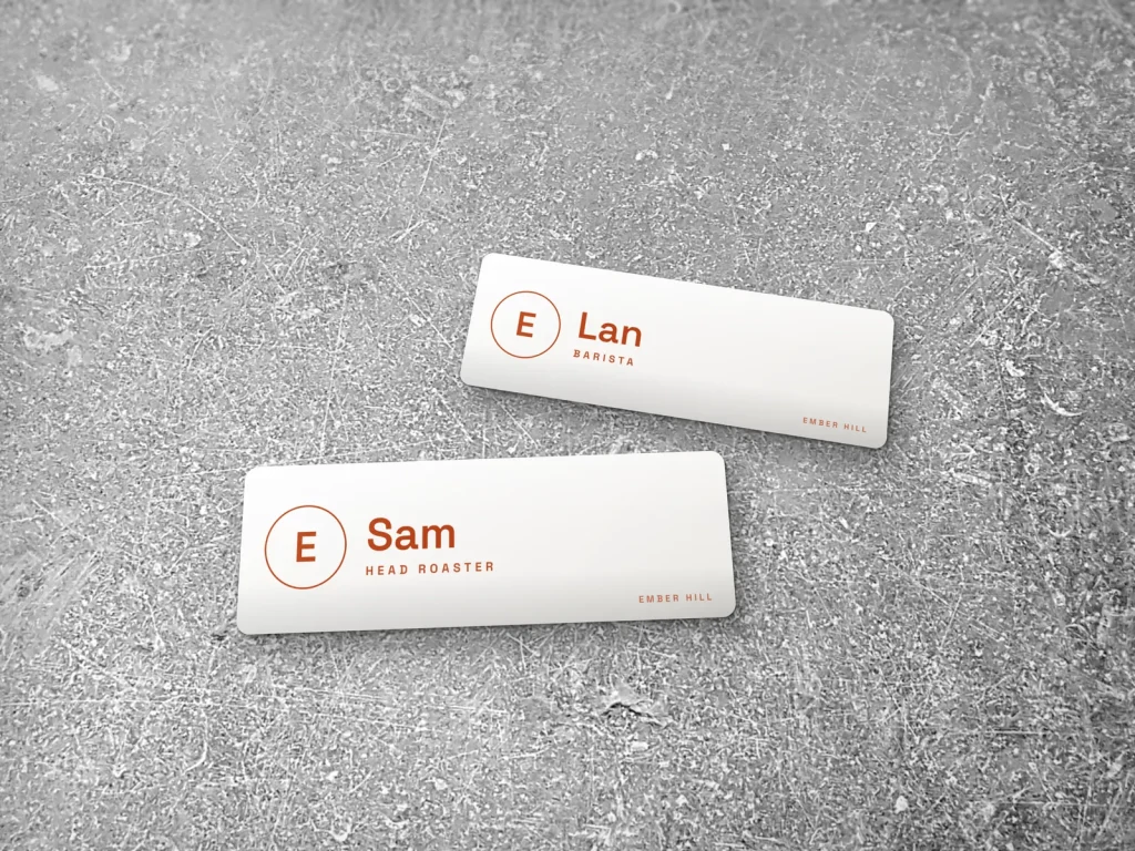 Mẫu name tag NT-16 cho tiệm bánh và café: Ember Hill, nền trắng chữ cam đậm